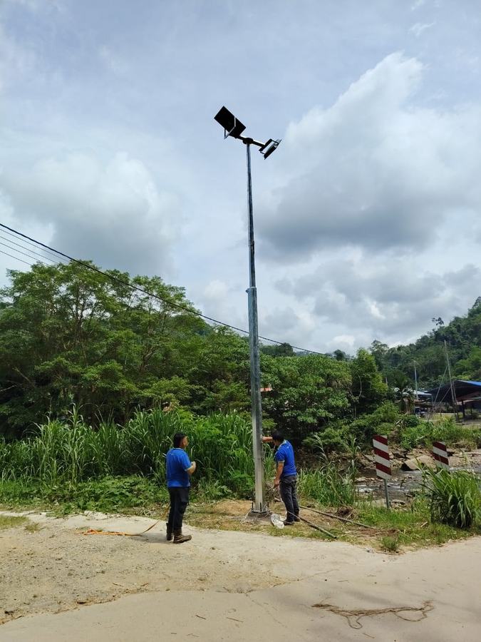 Technicians installing a solar lighting pole in Tambunan